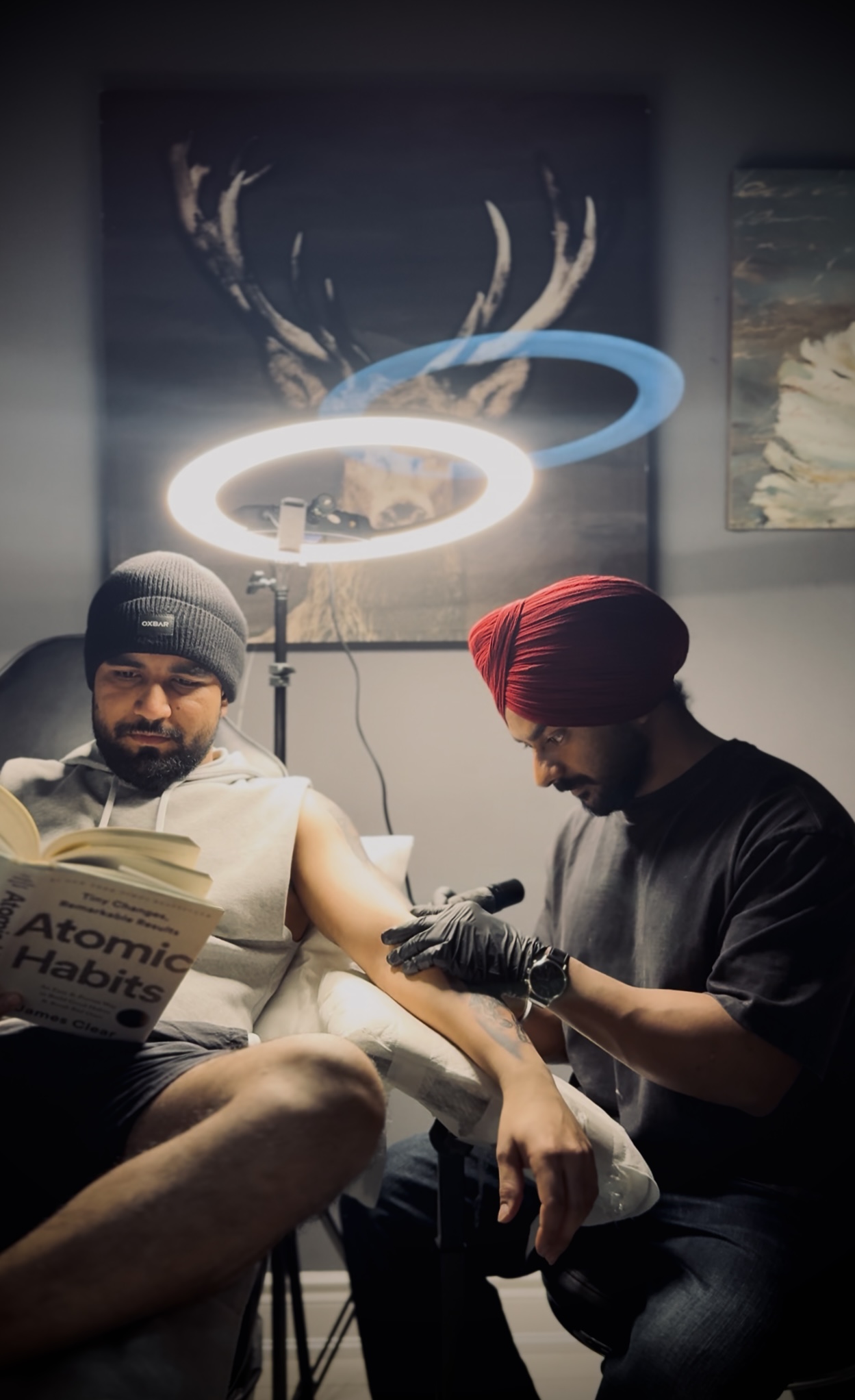 Navtej Singh tattooing a client